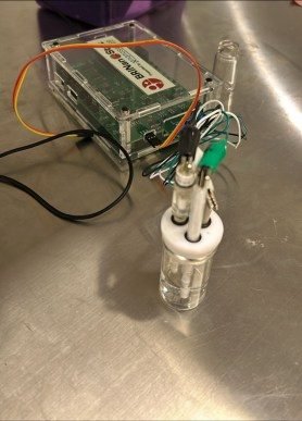 Portable potentiostat connected to a small electrochemical cell